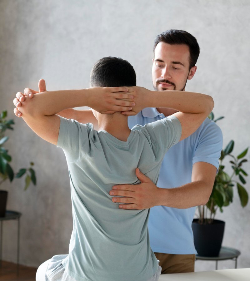 A man giving a back massage to Employee as a part of Workplace wellness program